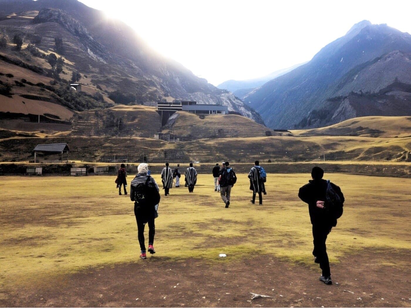 Pilgrims walking toward Chavin de Huantar in golden morning light