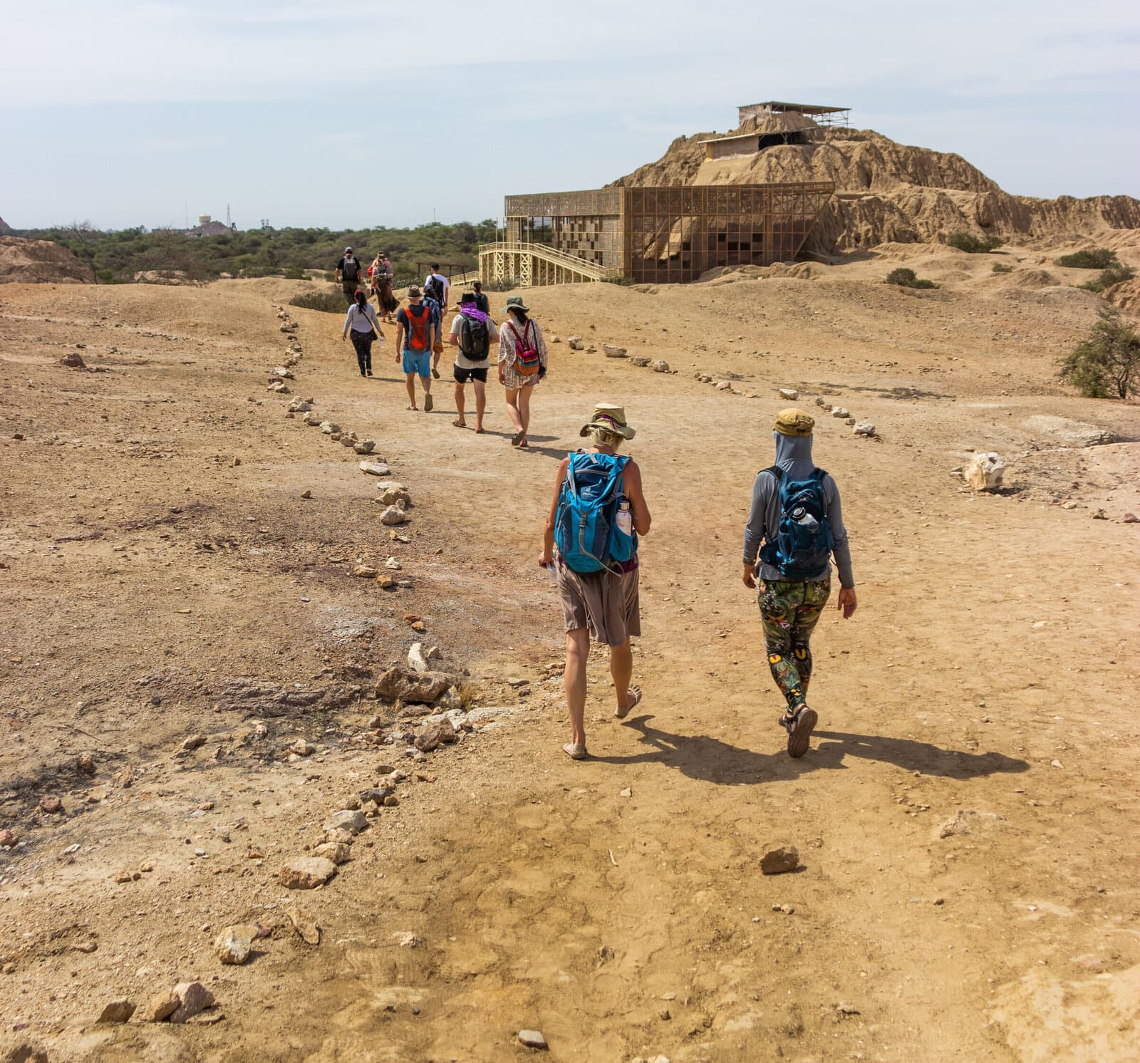 Pilgrims walking toward an ancient pyramid