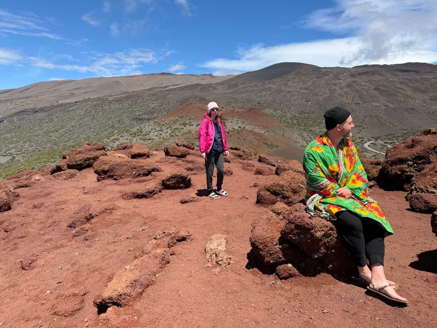 Sacred Ways participants on a red volcanic landscape against the Big Island sky
